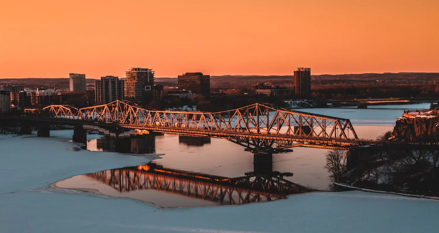 The Ottawa skyline at dusk over the river — local consulting, on the ground.